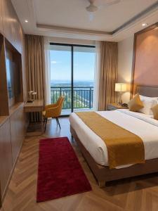a hotel room with a bed and a large window at Hotel Grand Marina Near IGI Airport Delhi in Bichpuri +18 photos