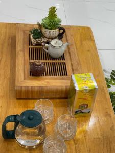 a wooden table with a box and glasses on it at Homestay giữa trung tâm Hải Phòng in An Dương