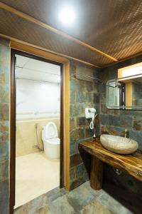a bathroom with a sink and a toilet at Fullhouse Mộc Châu in Mộc Châu +19 photos
