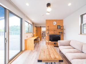 a living room with a couch and a table at Mobile Home 8 in Hokuto