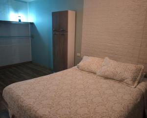 a bedroom with a bed with a pillow on it at Casa hospedaje en el campo in Temuco