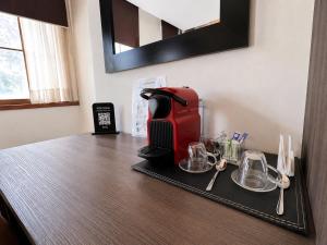 a coffee maker on a tray on a counter at BHB Hotel Boutique in Santiago +31 photos