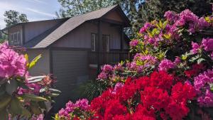 a small house surrounded by flowers at Emerald Retreat in Eugene