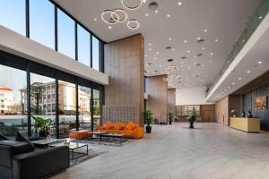 a lobby with orange furniture in a large building at Manior PentStudio West Lake Accomadi in Hanoi
