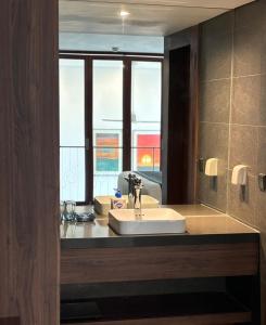 a bathroom with a sink and a large window at Manior PentStudio West Lake Accomadi in Hanoi