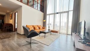 a living room with a couch and a television at Manior PentStudio West Lake Accomadi in Hanoi