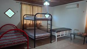 a room with two bunk beds and a chair at La almeja in Nueva Gorgona