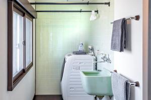a green bathroom with a sink and a toilet at La Pace Awaji in Osaka +28 photos