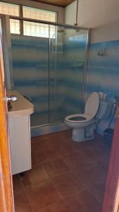 a bathroom with a toilet and a glass shower at La almeja in Nueva Gorgona +10 photos