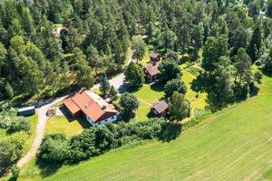 an aerial view of a house in a field at Cozy Cottage By Töcksfors Lakes in Töcksfors