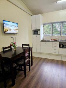 a kitchen with a table and chairs in a room at Aurora Mirage Apartments in Nadi