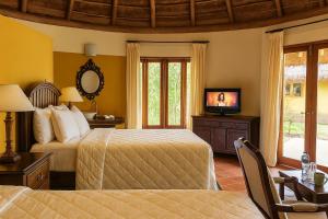 a hotel room with two beds and a television at Nzuri House in Nairobi