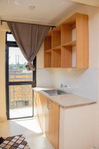 a kitchen with a sink and a window at ACARA HAVEN Kisumu in Kisumu