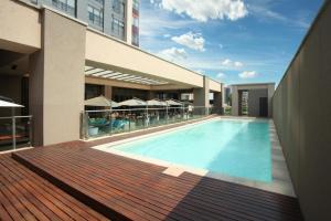 a swimming pool in the middle of a building at Sandton Skye Apartments in Johannesburg