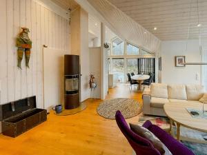 a living room with a couch and a fireplace at Seaside Cabin With Private Pier In Eidsvåg in Eidsvåg +5 photos