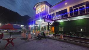 a building with a motorcycle parked in front of it at Hotel Shubh Yatra in Nandaprayāg