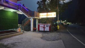 a gas station on the side of a street at night at Hotel Shubh Yatra in Nandaprayāg