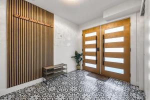 a hallway with a wooden door and a tile floor at Bunny Bliss - Upper Level HotTub FirePit Theatre in Langley