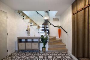 a hallway with a staircase with a table and a plant at Bunny Bliss - Upper Level HotTub FirePit Theatre in Langley