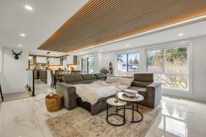 a living room with a couch and a table at Bunny Bliss - Upper Level HotTub FirePit Theatre in Langley +45 photos