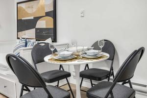 a dining room with a white table and chairs at Bunny Bliss - Lower Level HotTub FirePit Theatre in Langley +21 photos