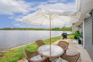 a table with chairs and an umbrella on a patio at Lakefront - Grill - Bunk Beds - Sleeps 6 in Akron
