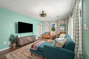 a living room with a blue couch and a flat screen tv at Lakefront - Grill - Bunk Beds - Sleeps 6 in Akron