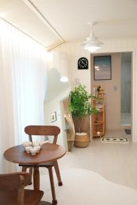 a living room with a table and a chair at Yeosu1944 in Yŏsu