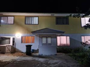 a house with a light on the front of it at Talipaea Lodge in Nuku‘alofa +2 photos