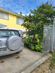 a car parked in a driveway next to a fence at Talipaea Lodge in Nuku‘alofa