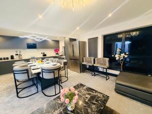 a kitchen and living room with a table and chairs at Bel Casa Solihull in Solihull