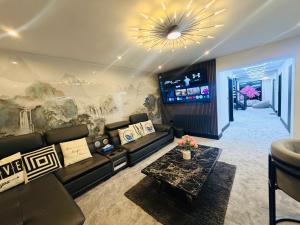 a living room with a couch and a table at Bel Casa Solihull in Solihull