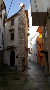 an alley with a stone building on a street at Old Town Baska in Baška