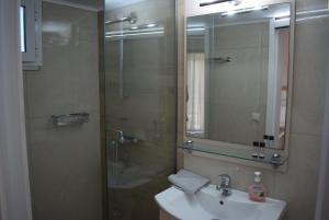 a bathroom with a sink and a shower with a mirror at Lydia Rooms & Studios in Preveza +53 photos
