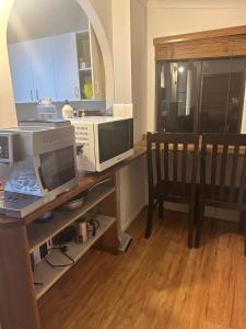 an office with a desk with a computer and a chair at Tranquil Waters Edge Escape in Sanctuary Point +27 photos