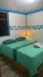 a bedroom with a large bed with a television at PENSION NATIRENA LODGE Hao in Otepa
