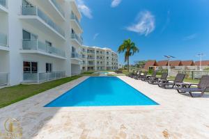 a swimming pool in front of a building at Aura Sosua Ocean Village in Sosúa