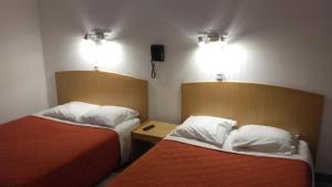 Postel nebo postele na pokoji v ubytování Hotel Le Chapitre + 10 fotografií