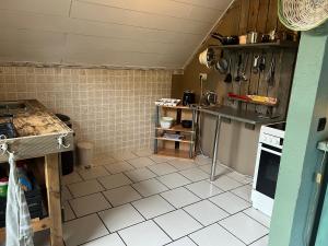 a kitchen with a white tiled floor and a counter at Appartement 9 Nichtraucherappartement in Coesfeld