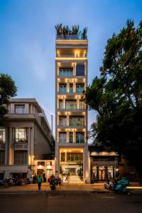 a tall building with a tree on top of it at IconSphere Hotel in Ho Chi Minh City