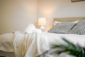 a bedroom with a bed with a lamp on it at Seednest Stylish & Perfect for Relaxation in Melton South