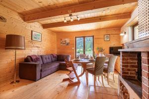 a living room with a couch and a table at Kraševec Lodge with Garden & Pool - Happy Rentals in Velike Bloke