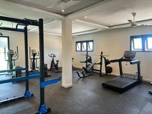 a gym with several tread machines in a room at Tanji Cliffs in Tanji