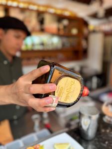 a person holding up a jar of food at Hosteria Casa Silva in Checa +26 photos