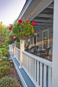 a porch with flowers in a pot on a house at Sylvan Inn Bed & Breakfast in Glen Arbor