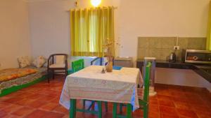 a kitchen with a table and chairs in a room at The Nagri Resort in Pālampur