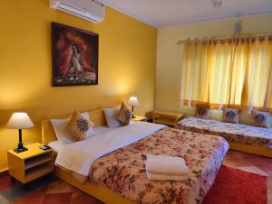a bedroom with two beds and a painting on the wall at The Nagri Resort in Pālampur +62 photos