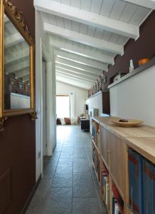 a hallway with a mirror on the wall and a living room at La Vedetta in Vercana