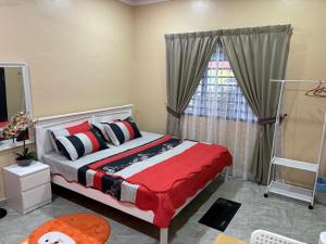 a bedroom with a bed and a large window at Farshada Homestay villa in Kapar
