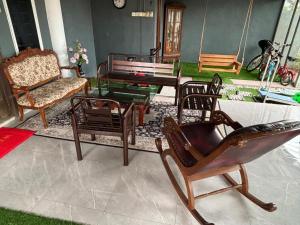 a living room filled with furniture and a piano at Farshada Homestay villa in Kapar